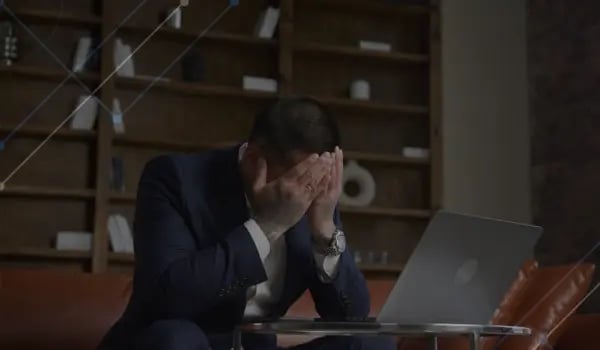 Frustrated investor with head in hands at a desk - The Fall of Venture Capital and OpenAI overconcentration