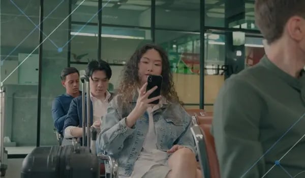 International tech workers waiting at an airport - Trump's $100k H1B visa: big tech wins, startups lose