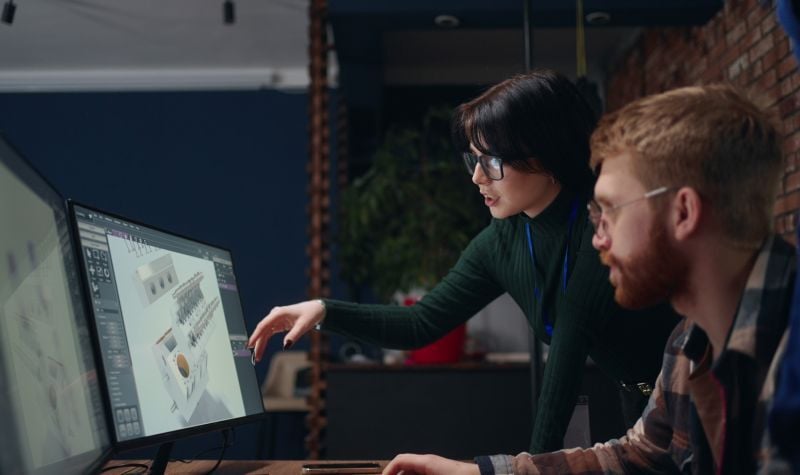 Engineers reviewing a 3D model design