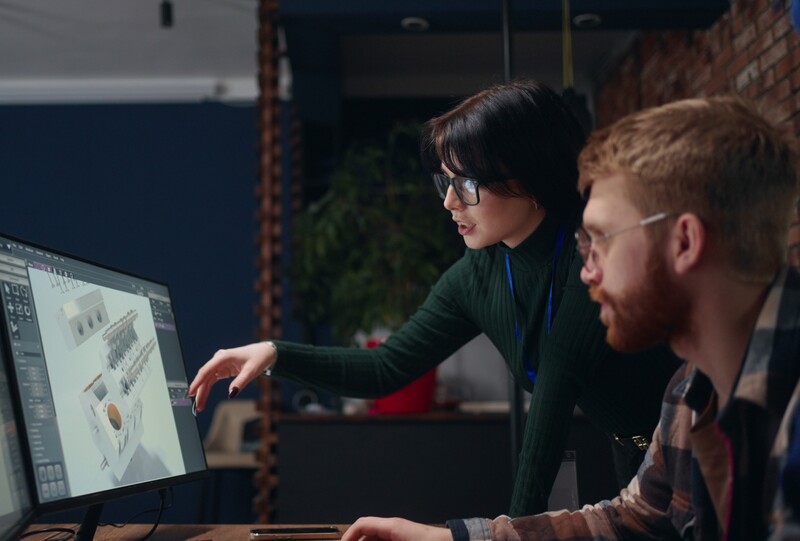 cropped_team-of-engineers-discussing-3d-model-of-new-engine-looking-at-display-and-talking-tea-SBI-349598213-1