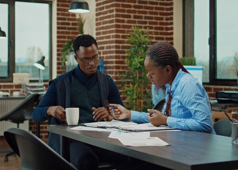 department-members-reviewing-paperwork-in-boardroom-office-meeting-to-discuss-new-busi-SBI-349581237_crop_resize