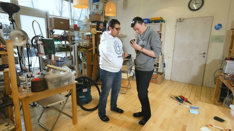 Engineers testing a robotic arm prototype