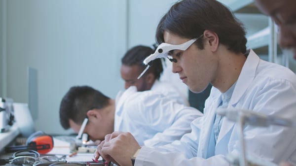 group-of-multiethnic-computer-engineers-in-lab-coats-repairing-and-assembling-motherbo-SBI-350611372-1